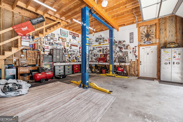 garage with a workshop area and refrigerator