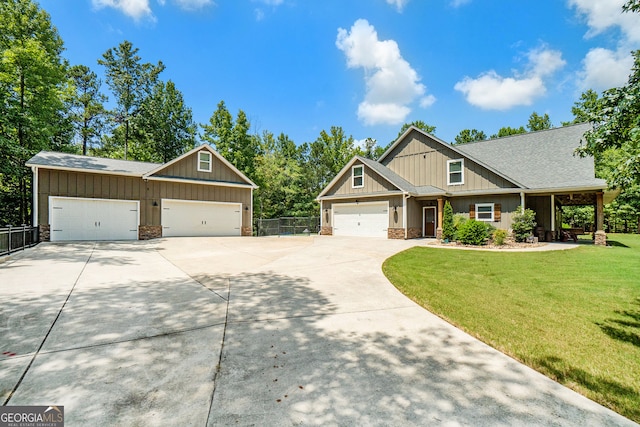 craftsman inspired home with a garage and a front yard