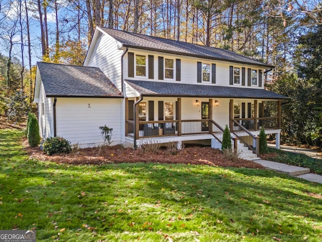 view of front facade featuring covered porch and a front lawn