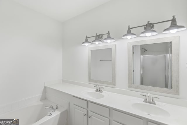 bathroom featuring vanity and separate shower and tub