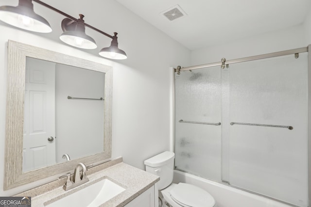 full bathroom with vanity, combined bath / shower with glass door, and toilet