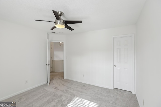 unfurnished bedroom featuring light carpet and ceiling fan