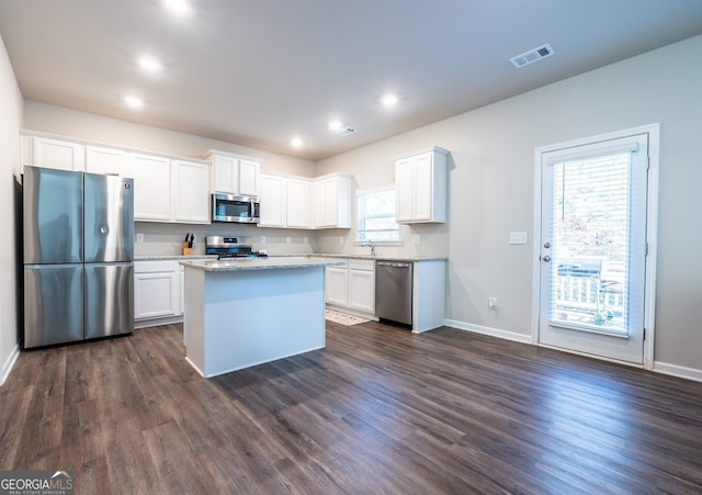 kitchen featuring white cabinetry, visible vents, stainless steel appliances, and dark wood finished floors