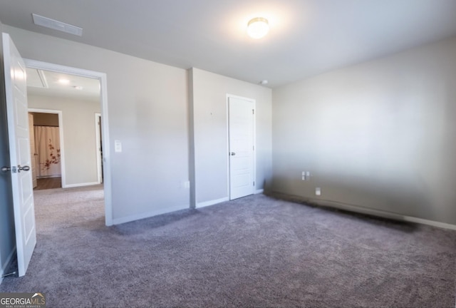 unfurnished bedroom featuring carpet, visible vents, and baseboards