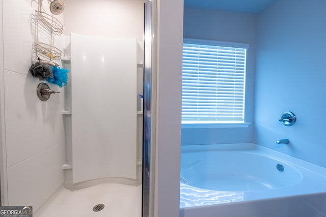 full bath with a garden tub and a shower stall