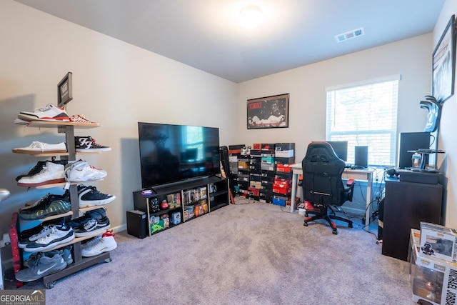 office area with visible vents and carpet flooring