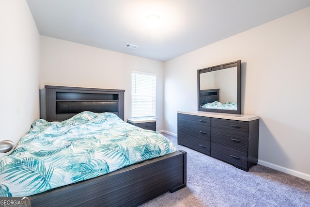 bedroom featuring carpet floors, visible vents, and baseboards