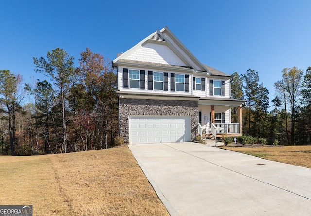 view of front of property with covered porch, concrete driveway, a garage, stone siding, and a front lawn