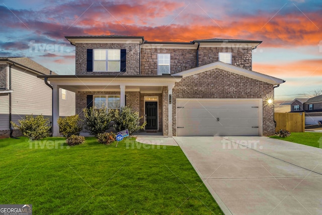 view of front facade featuring a garage and a lawn