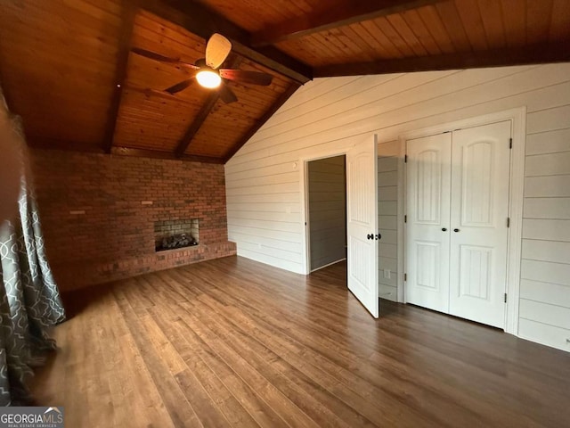 unfurnished living room with vaulted ceiling with beams, wood ceiling, dark hardwood / wood-style floors, and wood walls