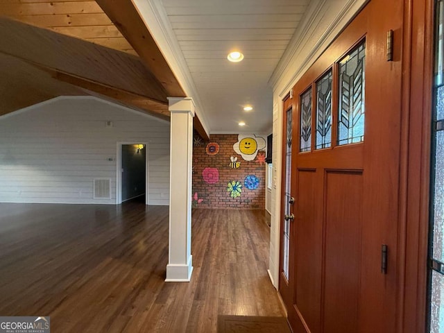 foyer entrance featuring lofted ceiling with beams, brick wall, and dark hardwood / wood-style floors