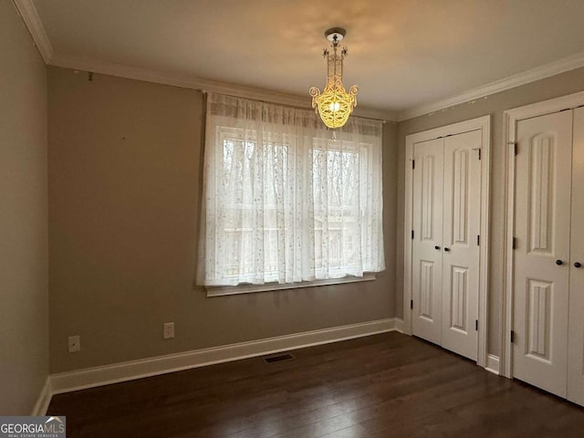 unfurnished dining area featuring crown molding and dark hardwood / wood-style flooring