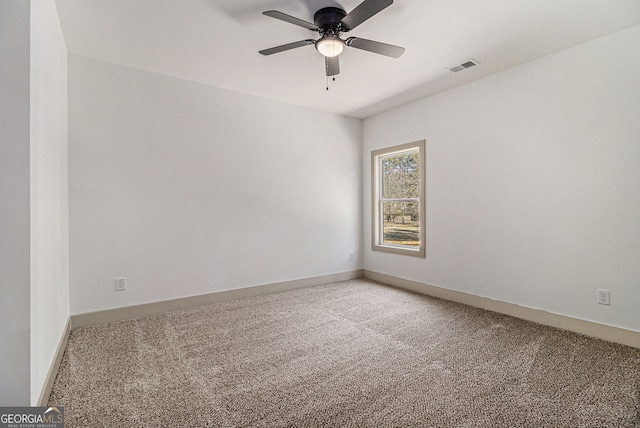 carpeted spare room with ceiling fan