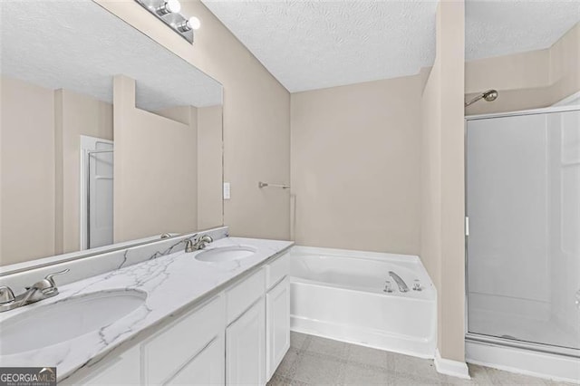 bathroom featuring vanity, independent shower and bath, and a textured ceiling