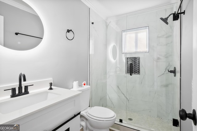 bathroom featuring ornamental molding, vanity, toilet, and a shower with shower door