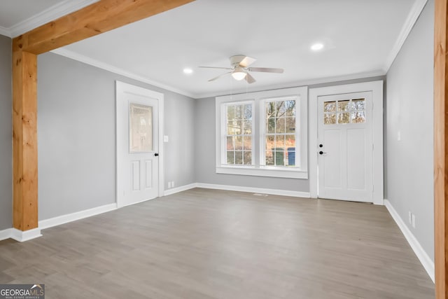 foyer with crown molding, hardwood / wood-style flooring, and ceiling fan