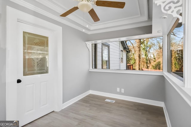 interior space with crown molding, ceiling fan, and wood-type flooring