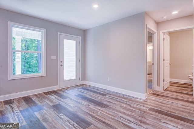 spare room featuring light hardwood / wood-style flooring