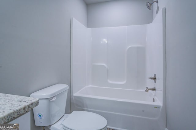 bathroom with bathing tub / shower combination and toilet