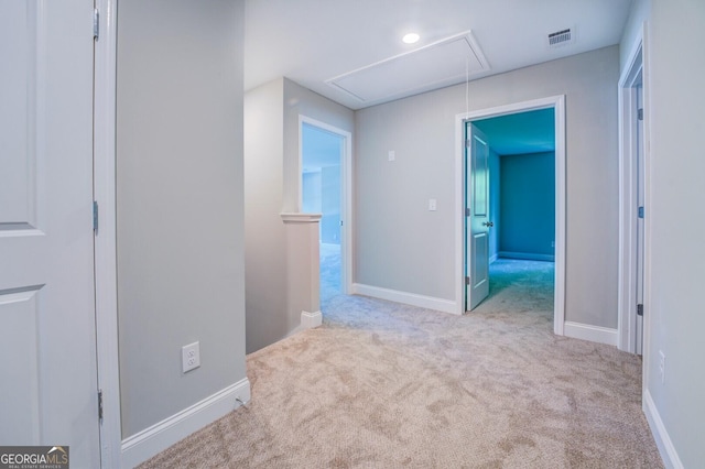 hallway with light colored carpet