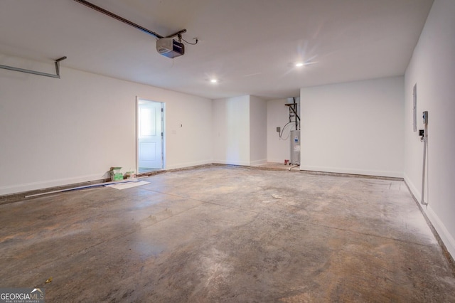 garage featuring water heater and a garage door opener