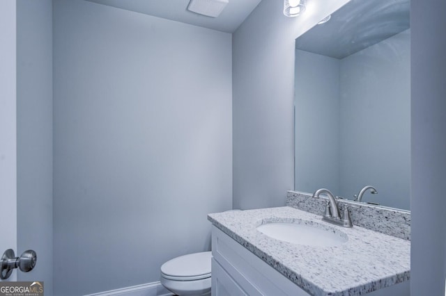 bathroom with vanity and toilet