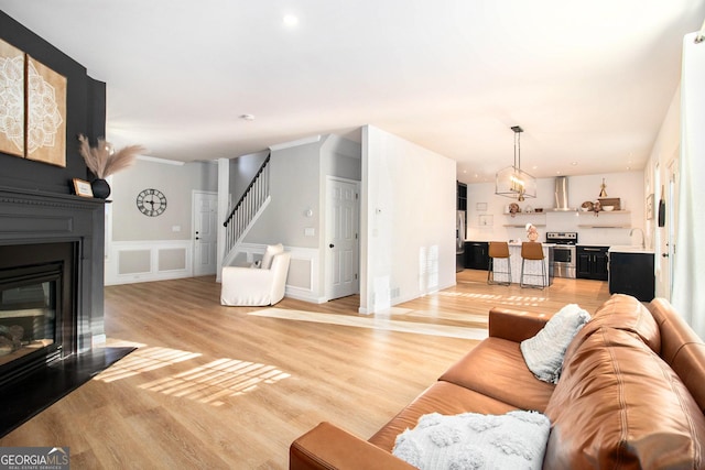 living room featuring sink and light hardwood / wood-style floors