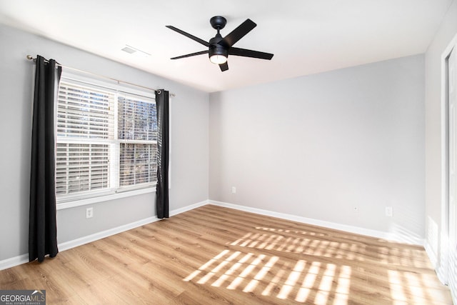 unfurnished room with ceiling fan and light wood-type flooring