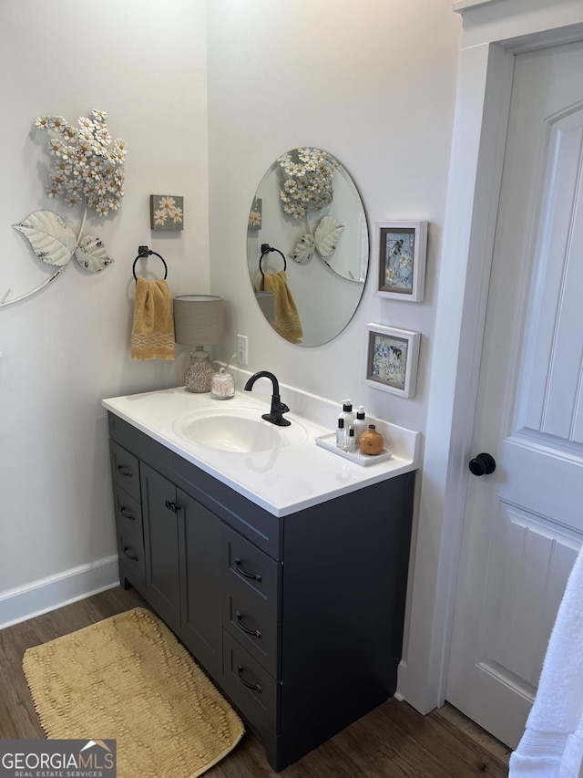 bathroom with vanity and hardwood / wood-style floors