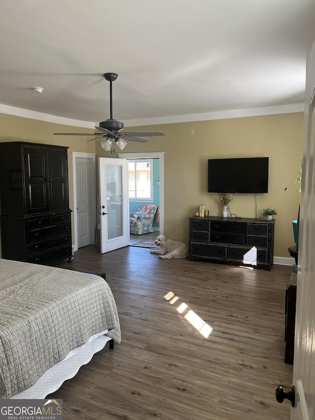 bedroom with french doors, ornamental molding, dark hardwood / wood-style floors, and ceiling fan