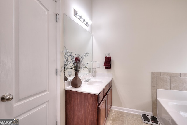 bathroom featuring tile patterned flooring, vanity, and a bathing tub