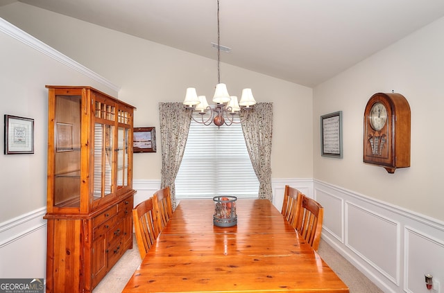 dining area with an inviting chandelier and lofted ceiling