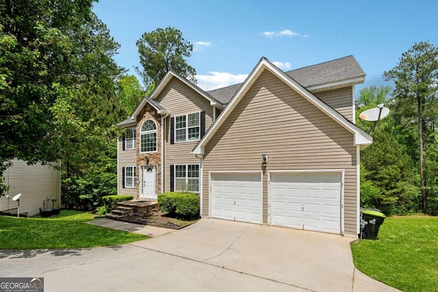 view of front of house featuring a garage and a front yard