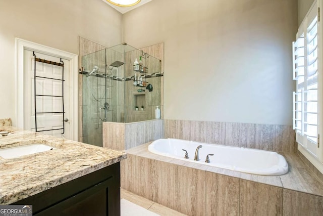 bathroom with vanity and independent shower and bath