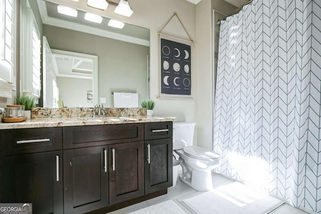 bathroom featuring vanity, tile patterned floors, ornamental molding, and toilet