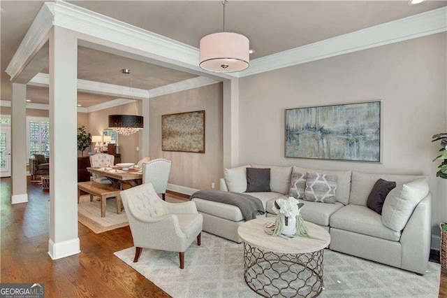 living room with crown molding and wood-type flooring