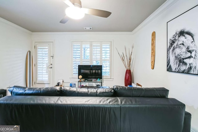 living room with ornamental molding and ceiling fan