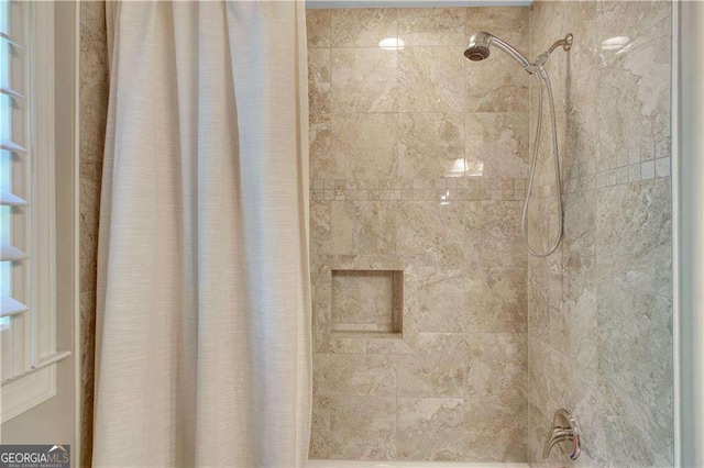 details featuring shower / bath combination with curtain