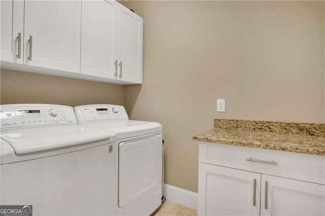 laundry area featuring cabinets and washer and clothes dryer