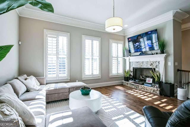 living room featuring dark hardwood / wood-style flooring, crown molding, and a premium fireplace