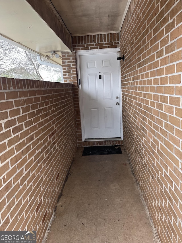 property entrance with brick siding