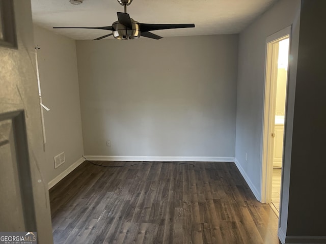 interior space featuring ceiling fan, visible vents, baseboards, and dark wood-type flooring