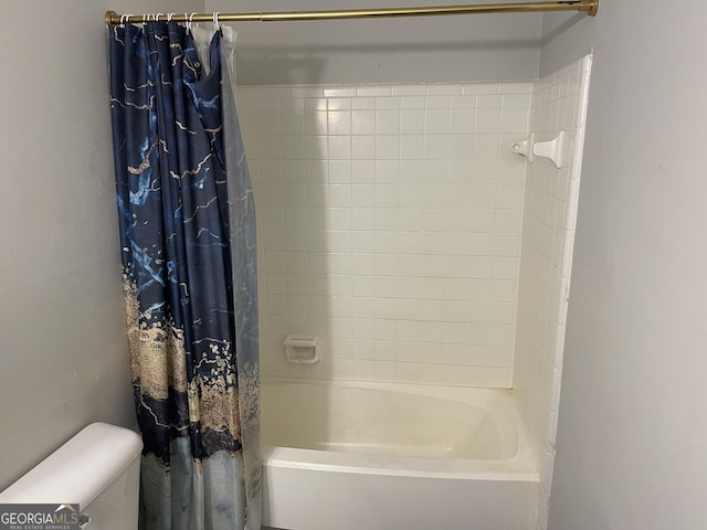 bathroom with shower / tub combo and toilet