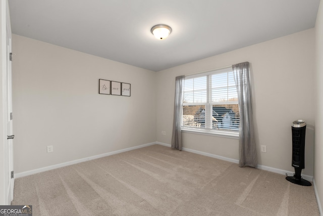 unfurnished room featuring light carpet