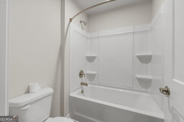 bathroom featuring shower / bathtub combination and toilet