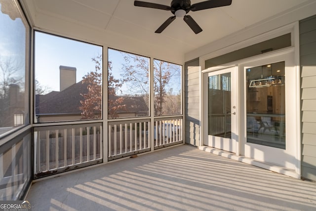 unfurnished sunroom with ceiling fan