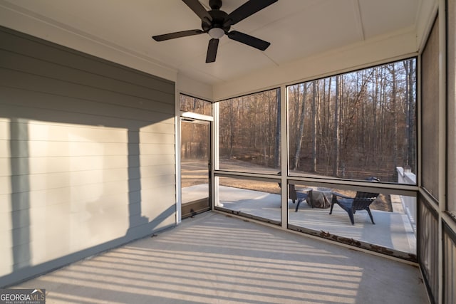 unfurnished sunroom featuring ceiling fan