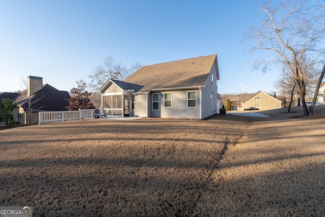 view of front facade with a sunroom and a front yard