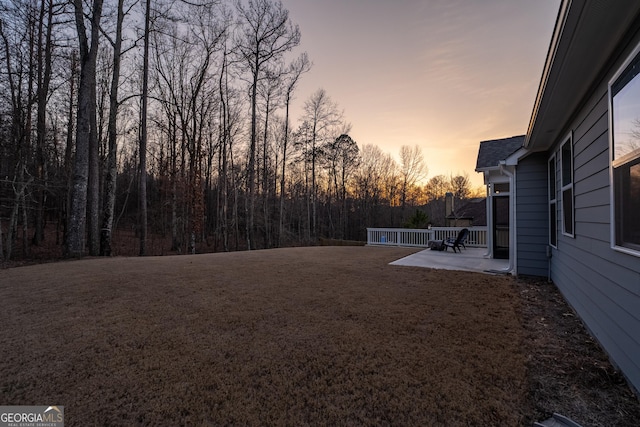 yard at dusk with a patio