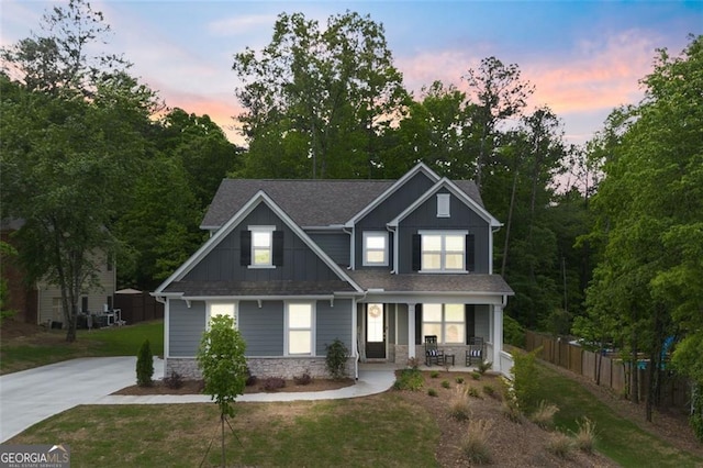 craftsman inspired home featuring a porch and a yard